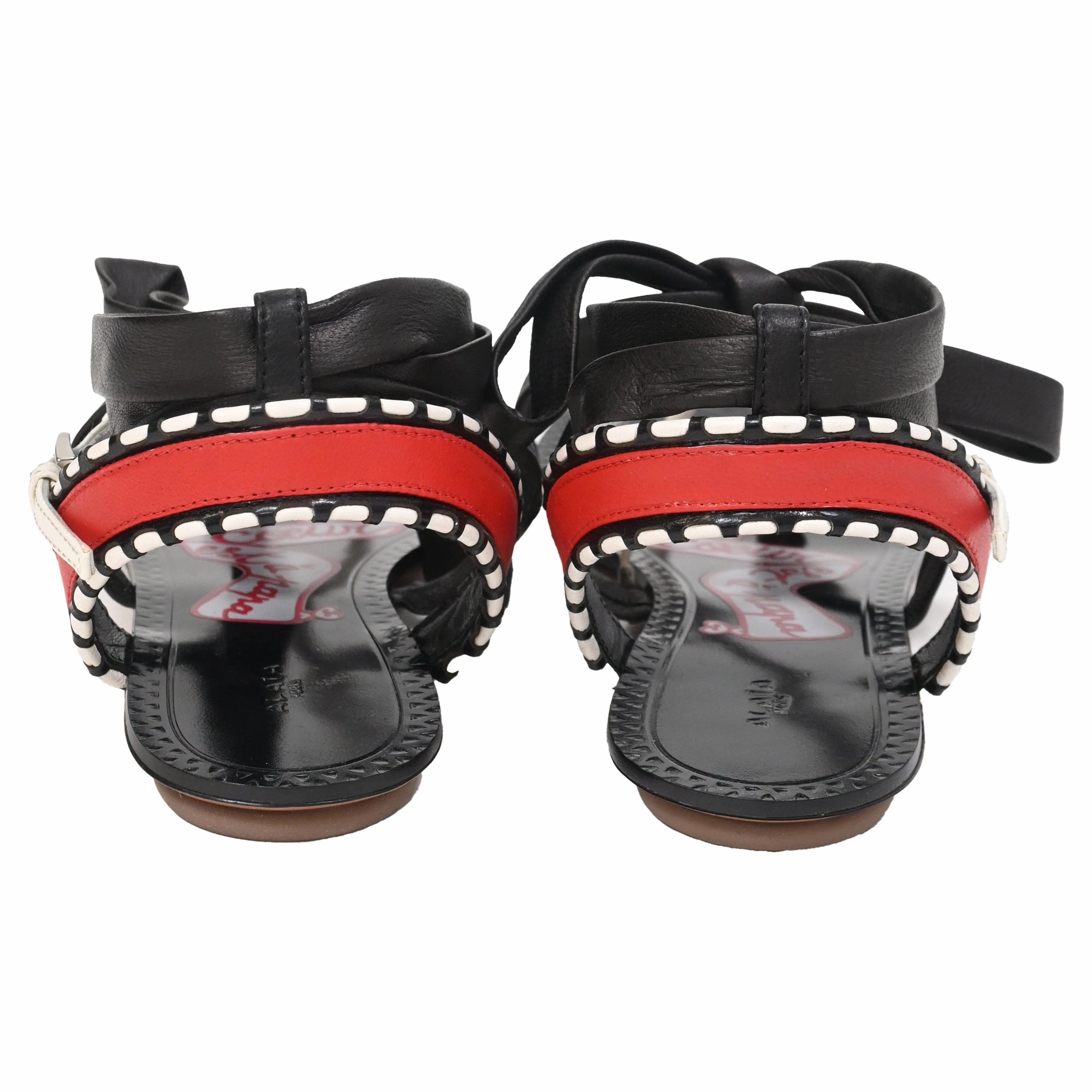 Alaa Graphic Print Gladiator Sandals in Black Leather